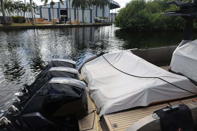 Slide: The Image of 2021 Vanquish Yachts VQ40 docked with covered deck and powerful outboard engines. - 22