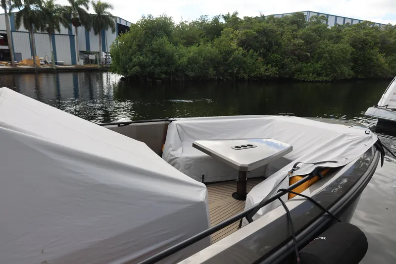 Slide: The Image of Vanquish Yachts VQ40 2021 model, docked with covered seating area and table. - 24