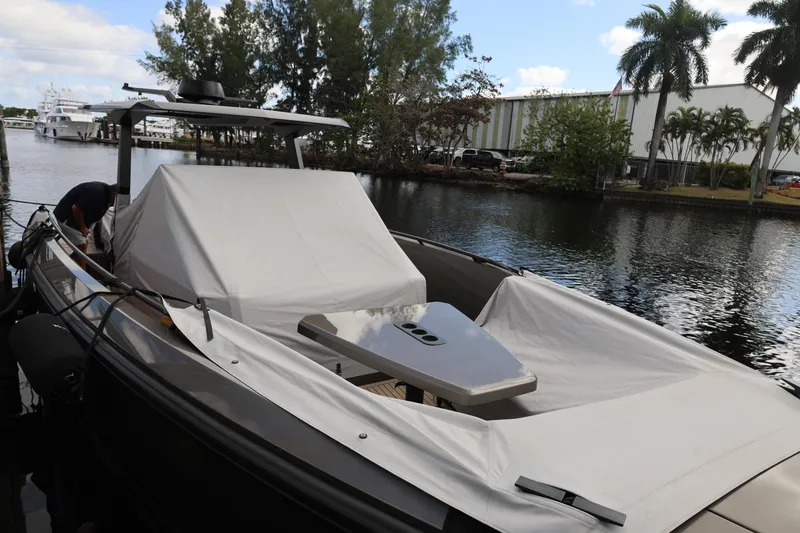 Slide: The Image of Vanquish Yachts VQ40 2021 model docked, covered, with lush surroundings. - 25