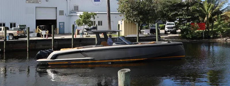 Slide: The Image of Vanquish Yachts VQ40 2021 model docked near a marina, sleek design and modern features. - 27
