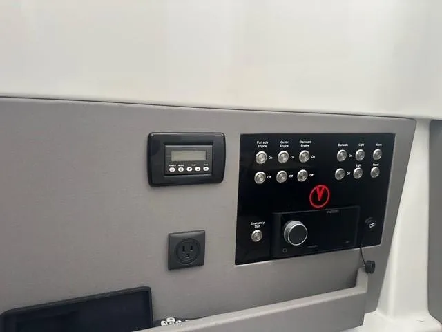 Slide: The Image of Control panel of 2021 Vanquish Yachts VQ40 with various switches and display. - 29