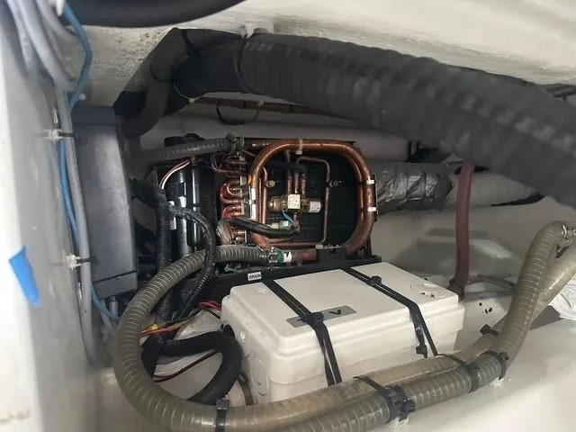 Slide: The Image of Engine compartment of 2021 Vanquish Yachts VQ40 with visible wiring and components. - 35