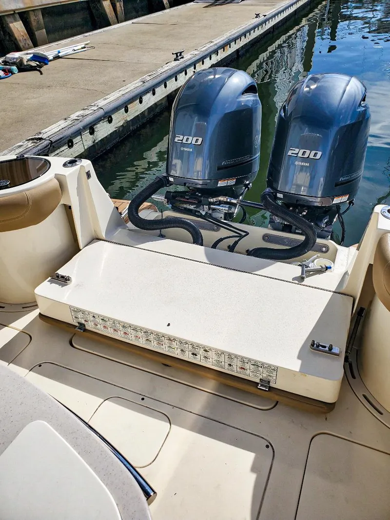 Slide: The Image of 2017 Scout 275 LXF boat with twin 200 horsepower engines docked at marina. - 15