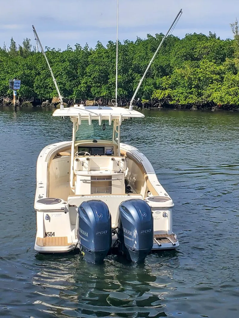 Slide: The Image of 2017 Scout 275 LXF boat with dual Yamaha engines on a calm waterway. - 17