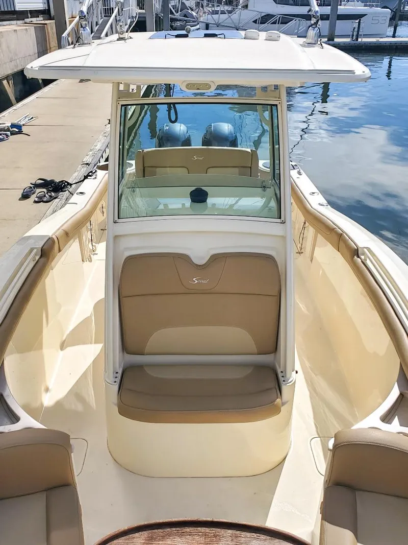 Slide: The Image of 2017 Scout 275 LXF boat with tan seating, docked at a marina. - 7