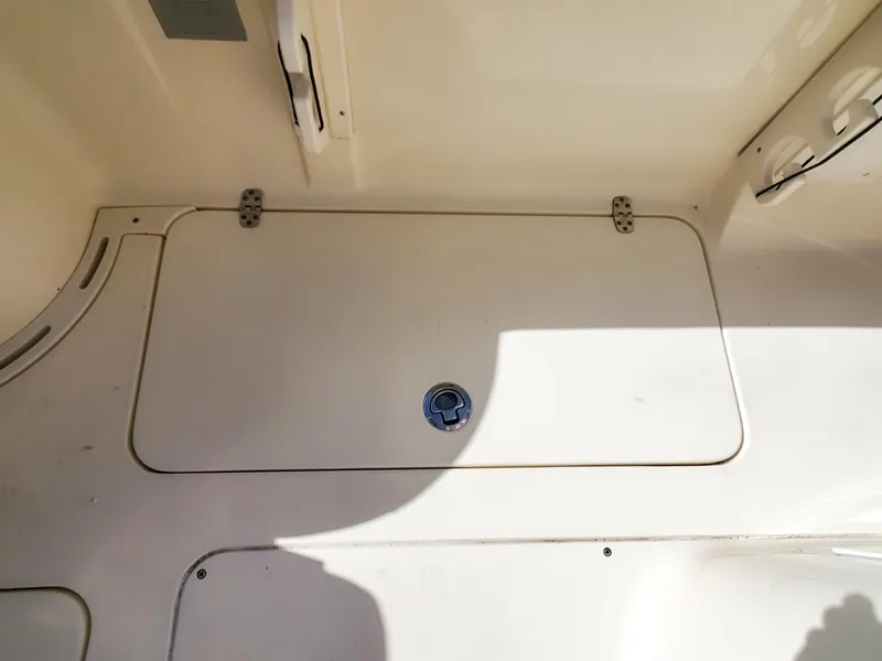 Slide: The Image of 2017 Scout 275 LXF boat deck hatch with latch, beige interior. - 9