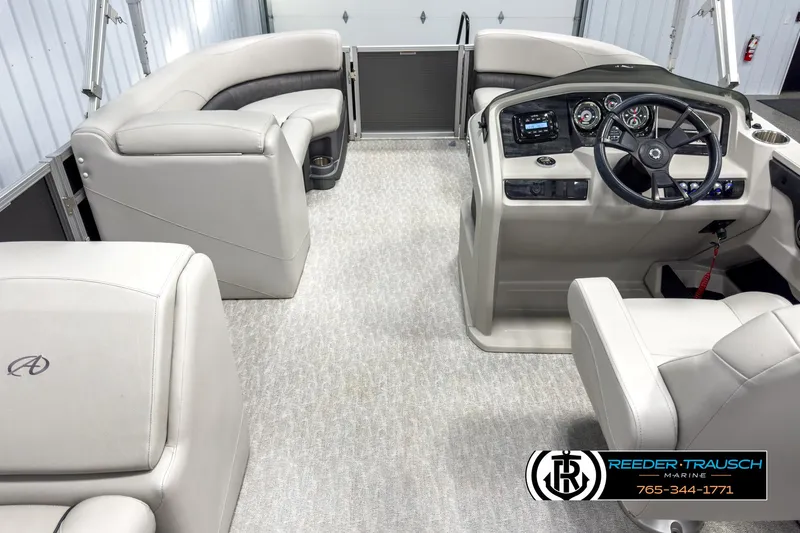Slide: The Image of 2020 Avalon 2285 LSZ CRB boat interior with plush seating and modern dashboard. - 18