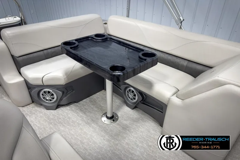 Slide: The Image of 2020 Avalon 2285 LSZ CRB boat interior with seating and table, featuring built-in speakers. - 24