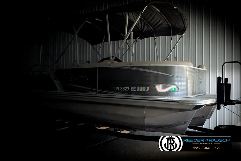 Slide: The Image of 2020 Avalon 2285 LSZ CRB pontoon boat in a dimly lit storage area. - 4
