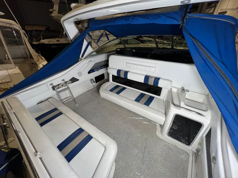 Slide: The Image of 1992 Sea Ray 370 Express Cruiser interior with blue and white seating and canopy. - 10
