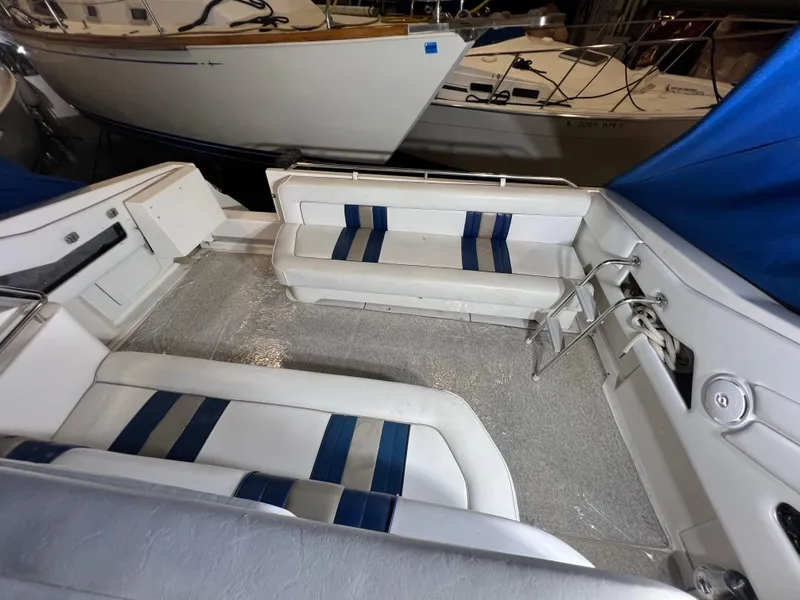 Slide: The Image of 1992 Sea Ray 370 Express Cruiser interior with white and blue seating. - 11
