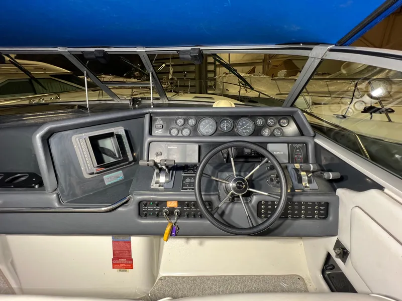 Slide: The Image of 1992 Sea Ray 370 Express Cruiser helm with steering wheel and instrument panel. - 12