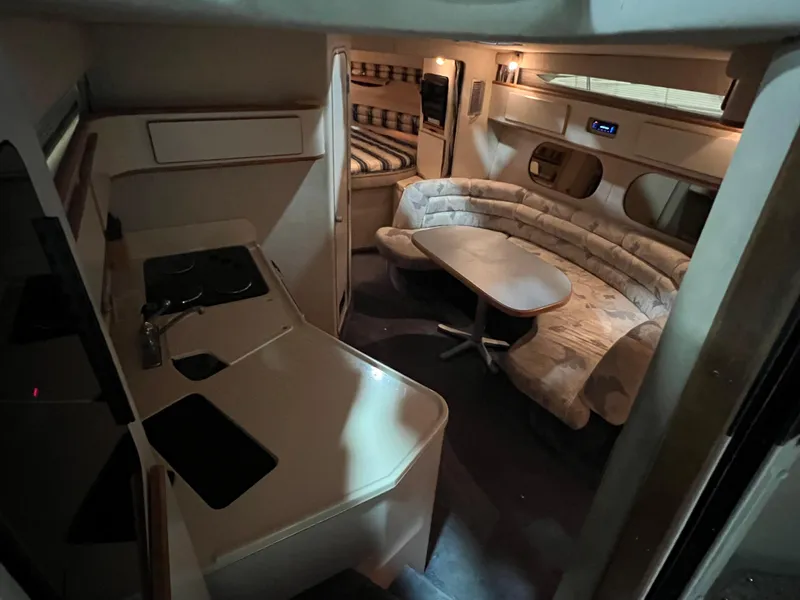 Slide: The Image of Interior of 1992 Sea Ray 370 Express Cruiser with kitchen and seating area. - 16