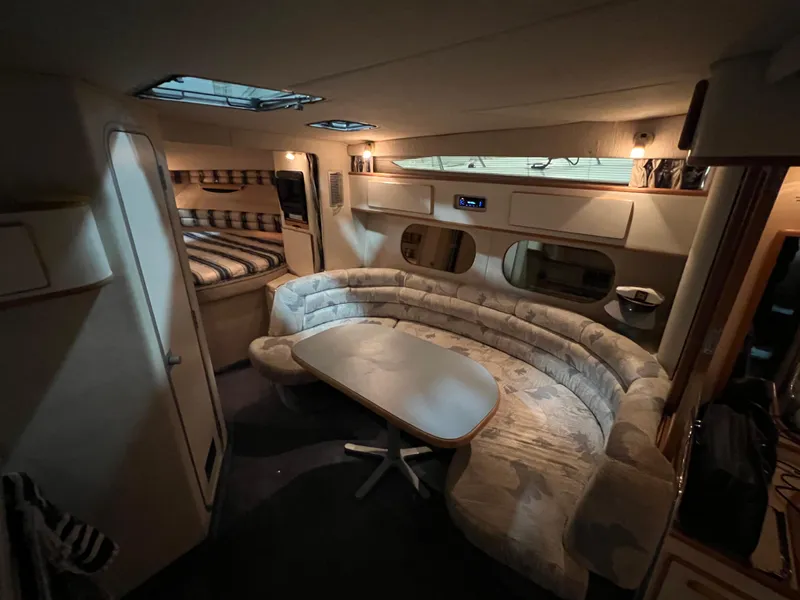 Slide: The Image of Interior of 1992 Sea Ray 370 Express Cruiser with cozy seating and dining area. - 17