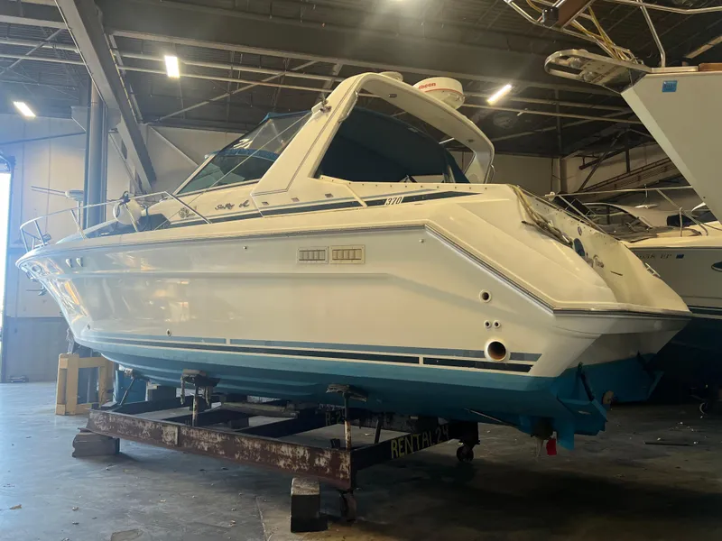 Slide: The Image of 1992 Sea Ray 370 Express Cruiser in a warehouse, side view. - 2