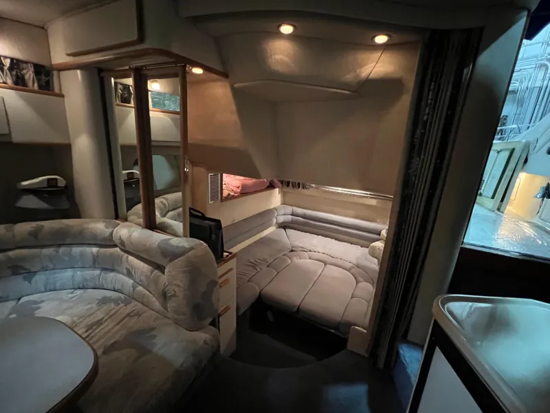 Slide: The Image of Interior of 1992 Sea Ray 370 Express Cruiser with cozy seating and ambient lighting. - 22