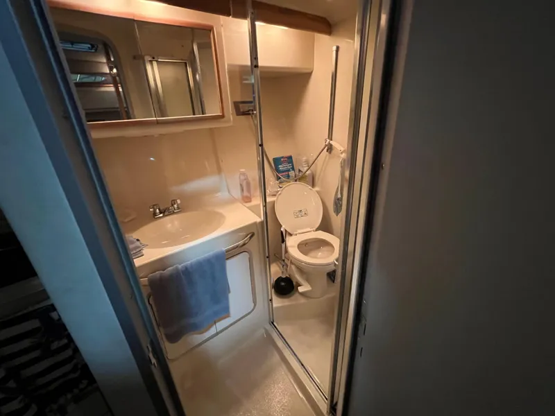 Slide: The Image of Bathroom interior of 1992 Sea Ray 370 Express Cruiser, featuring sink and toilet. - 25