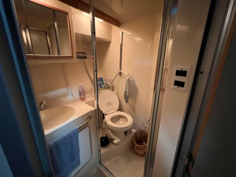 Slide: The Image of Bathroom interior of 1992 Sea Ray 370 Express Cruiser, featuring sink and toilet. - 26