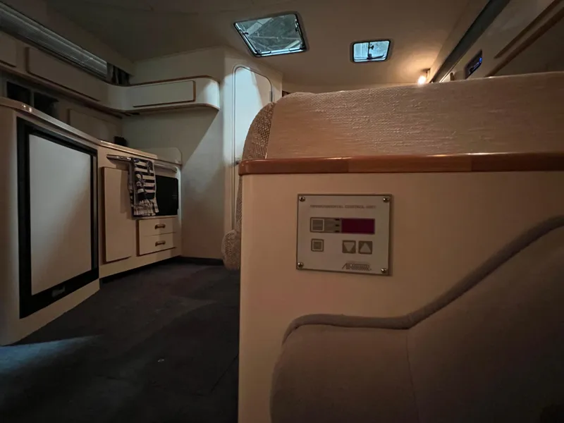 Slide: The Image of Interior of 1992 Sea Ray 370 Express Cruiser, featuring kitchen and seating area. - 27