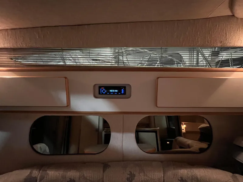 Slide: The Image of Interior of 1992 Sea Ray 370 Express Cruiser with modern control panel and mirrors. - 29