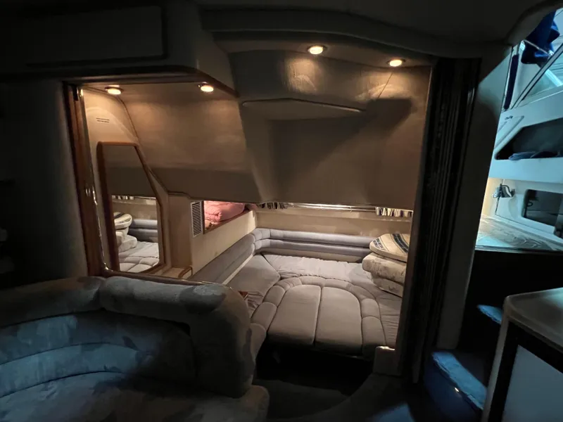 Slide: The Image of Interior of 1992 Sea Ray 370 Express Cruiser with cozy seating and ambient lighting. - 30