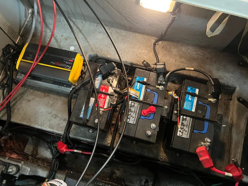 Slide: The Image of Battery compartment of a 1992 Sea Ray 370 Express Cruiser with wiring and charger. - 35