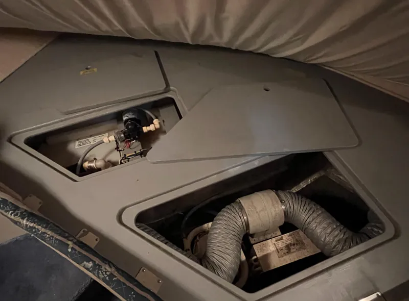 Slide: The Image of 1992 Sea Ray 370 Express Cruiser engine compartment with visible hoses and components. - 36