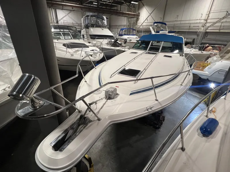 Slide: The Image of 1992 Sea Ray 370 Express Cruiser in indoor storage, surrounded by other boats. - 6