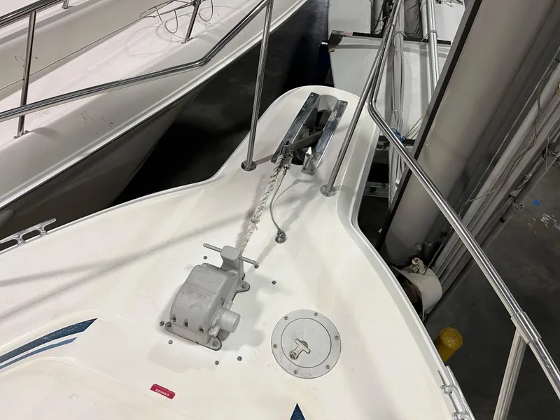 Slide: The Image of 1992 Sea Ray 370 Express Cruiser bow with anchor and railing in a marina. - 7