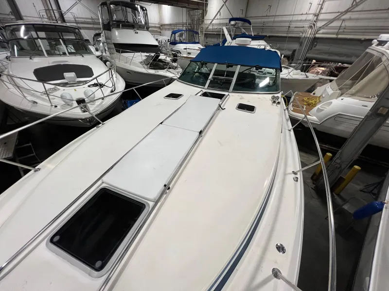 Slide: The Image of 1992 Sea Ray 370 Express Cruiser in a marina with other boats. - 8
