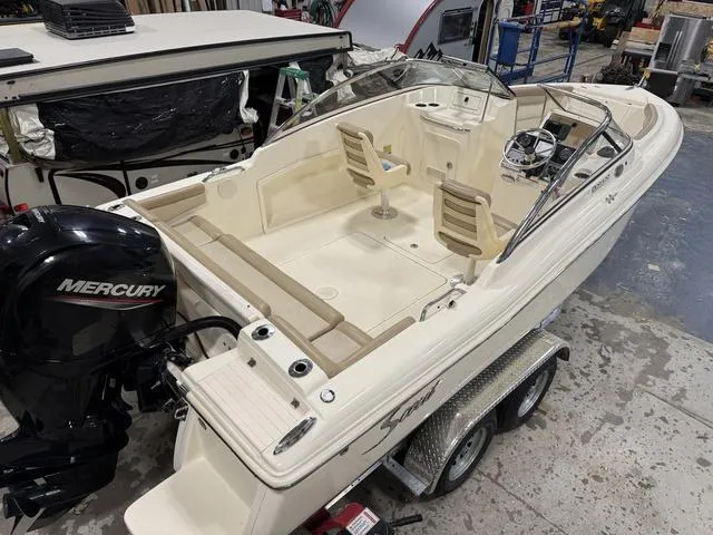 Slide: The Image of 2021 Scout 210 Dorado boat with Mercury engine on trailer in workshop. - 8