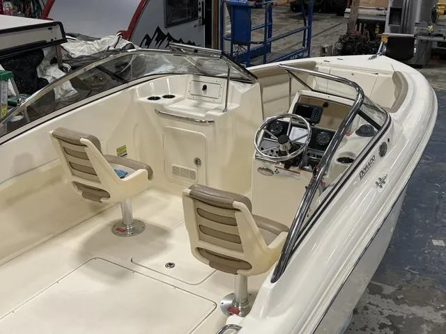 Slide: The Image of 2021 Scout 210 Dorado boat interior with dual seats and steering console. - 9
