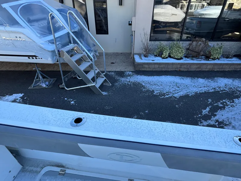 Slide: The Image of 2025 Defiance Admiral 220 EX boat with covered cockpit and metal stairs, parked on snowy pavement. - 11