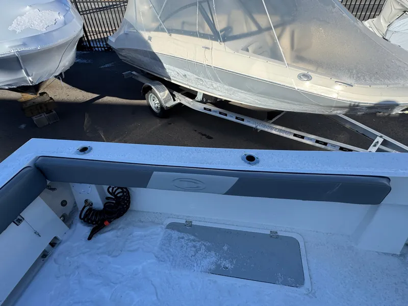 Slide: The Image of 2025 Defiance Admiral 220 EX boat interior with covered boats in background. - 13