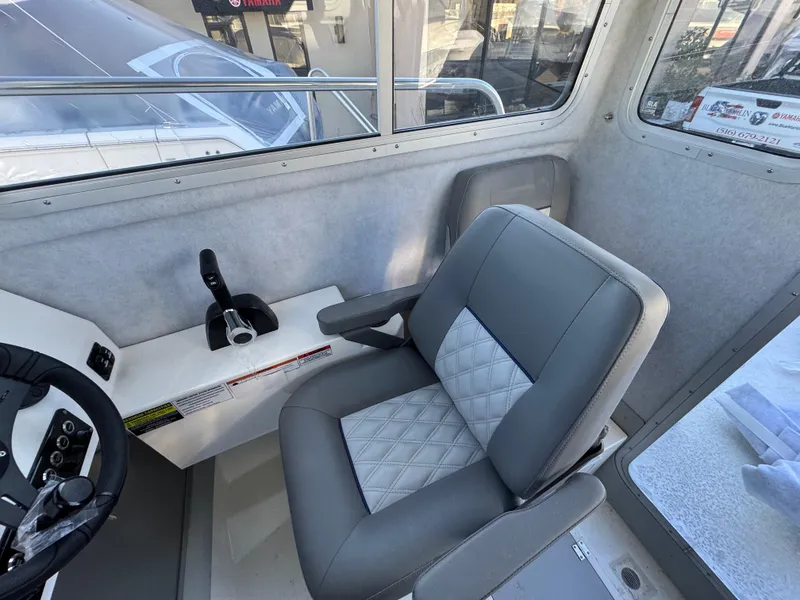 Slide: The Image of 2025 Defiance Admiral 220 EX interior with gray seating and control panel. - 9
