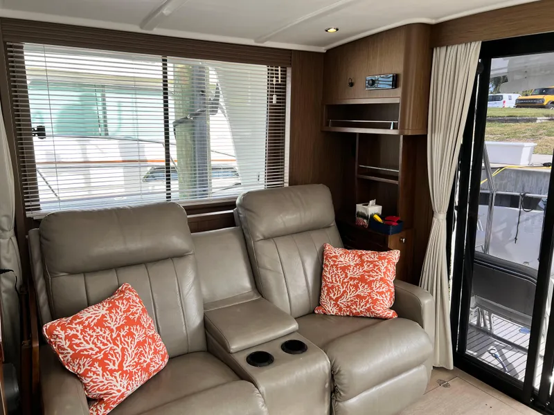 Slide: The Image of Interior of 2019 Beneteau Swift Trawler 44 with leather seating and decorative pillows. - 12
