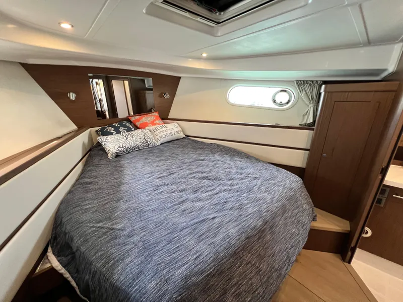 Slide: The Image of Cozy bedroom in 2019 Beneteau Swift Trawler 44 with modern design and porthole window. - 20
