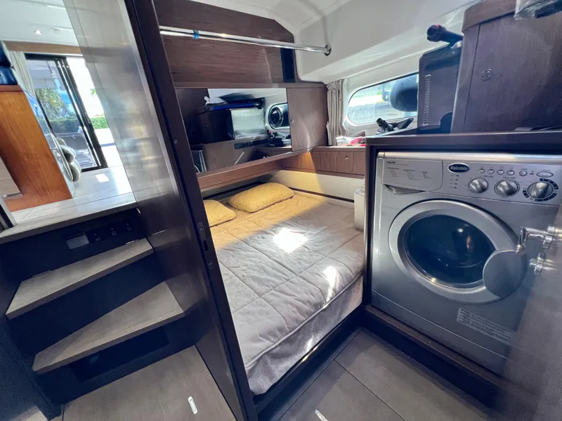 Slide: The Image of Interior of 2019 Beneteau Swift Trawler 44 with bed and washing machine. - 22