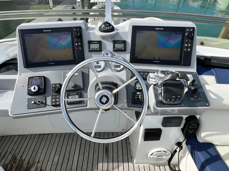 Slide: The Image of 2019 Beneteau Swift Trawler 44 helm with dual navigation screens and controls. - 4