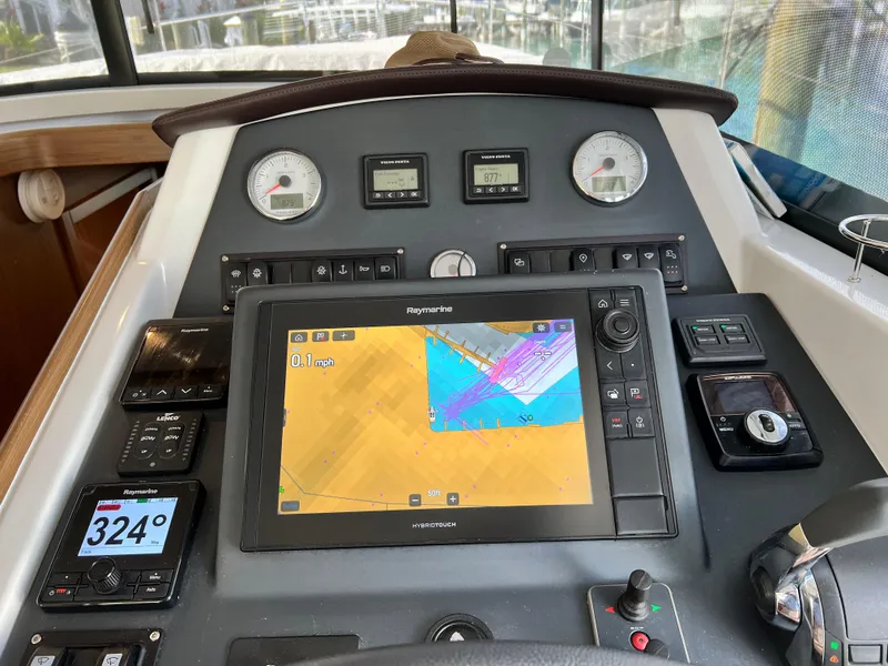 Slide: The Image of 2019 Beneteau Swift Trawler 44 helm with navigation display and controls. - 5