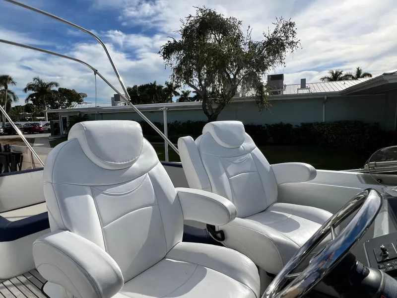 Slide: The Image of Luxurious white seats on 2019 Beneteau Swift Trawler 44 under a sunny sky. - 8
