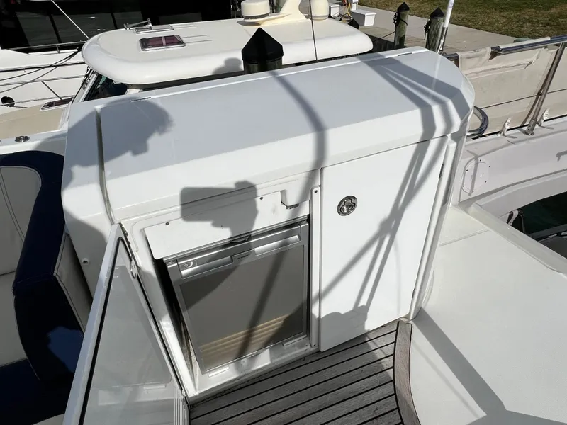 Slide: The Image of 2019 Beneteau Swift Trawler 44 deck with storage and stainless steel fridge. - 9