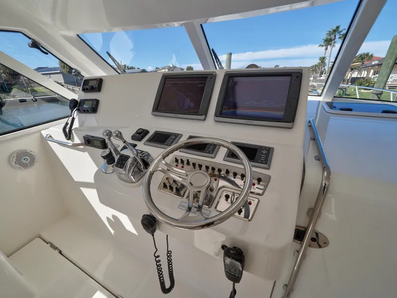 Slide: The Image of Cabo HTX 2013 boat helm with dual screens and control panel. - 2