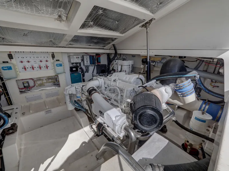Slide: The Image of Engine room of 2013 Cabo HTX boat with visible machinery and control panels. - 25