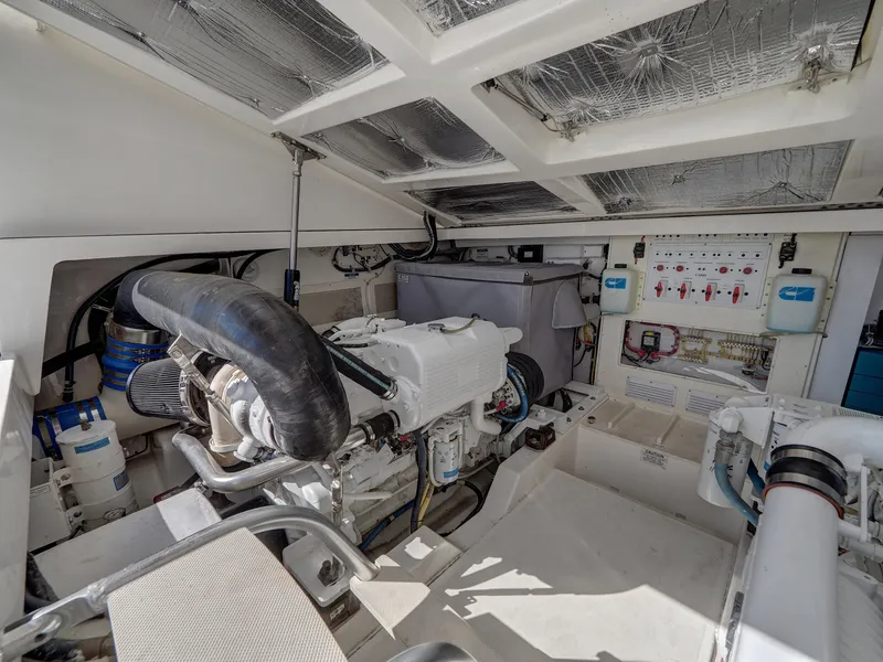 Slide: The Image of Engine room of 2013 Cabo HTX boat, showcasing mechanical components and control panels. - 26