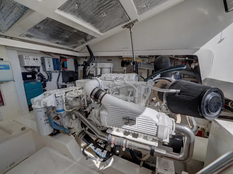 Slide: The Image of Engine room of a 2013 Cabo HTX boat, showcasing detailed mechanical components. - 27
