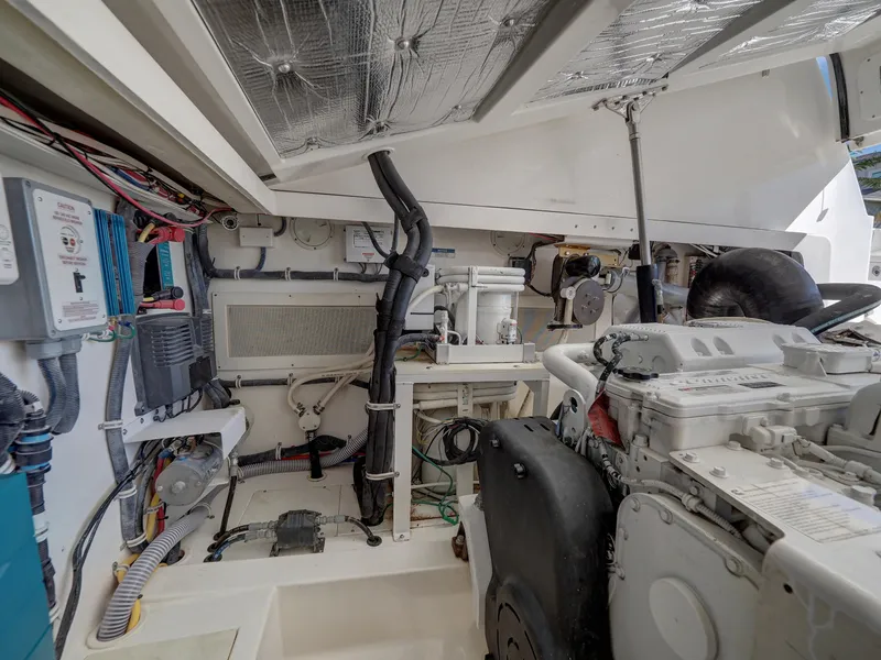 Slide: The Image of Engine room of 2013 Cabo HTX boat with visible wiring and machinery. - 29
