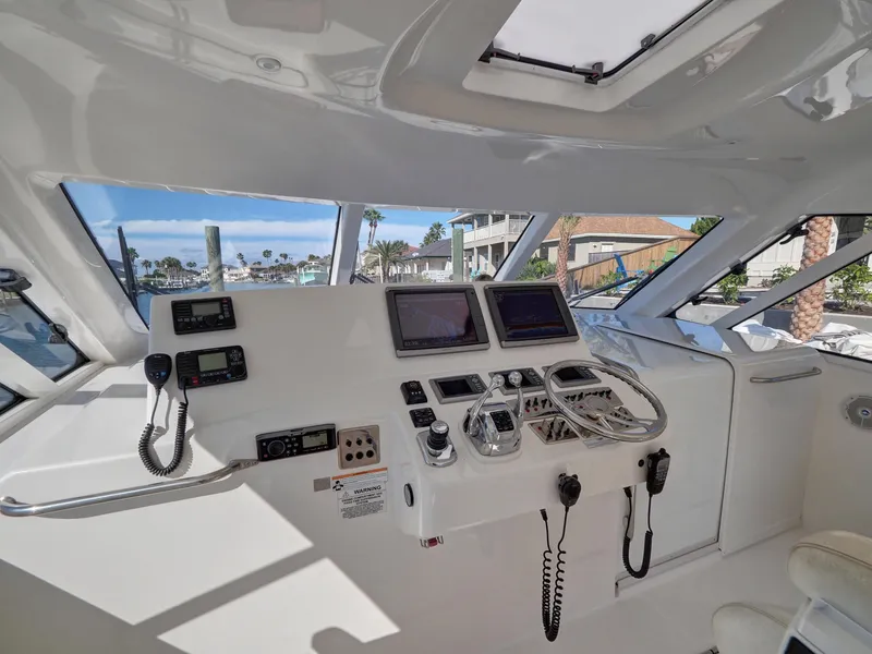 Slide: The Image of Interior view of 2013 Cabo HTX boat cockpit with navigation equipment and controls. - 3