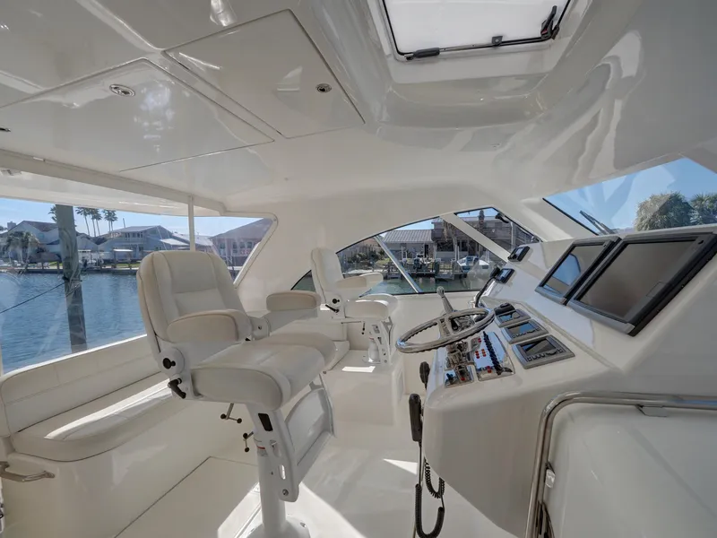 Slide: The Image of Luxurious 2013 Cabo HTX yacht interior with modern helm and plush seating. - 4