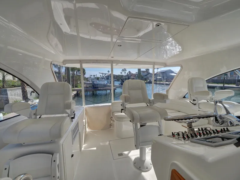 Slide: The Image of Luxurious 2013 Cabo HTX yacht interior with white seating and panoramic windows. - 7